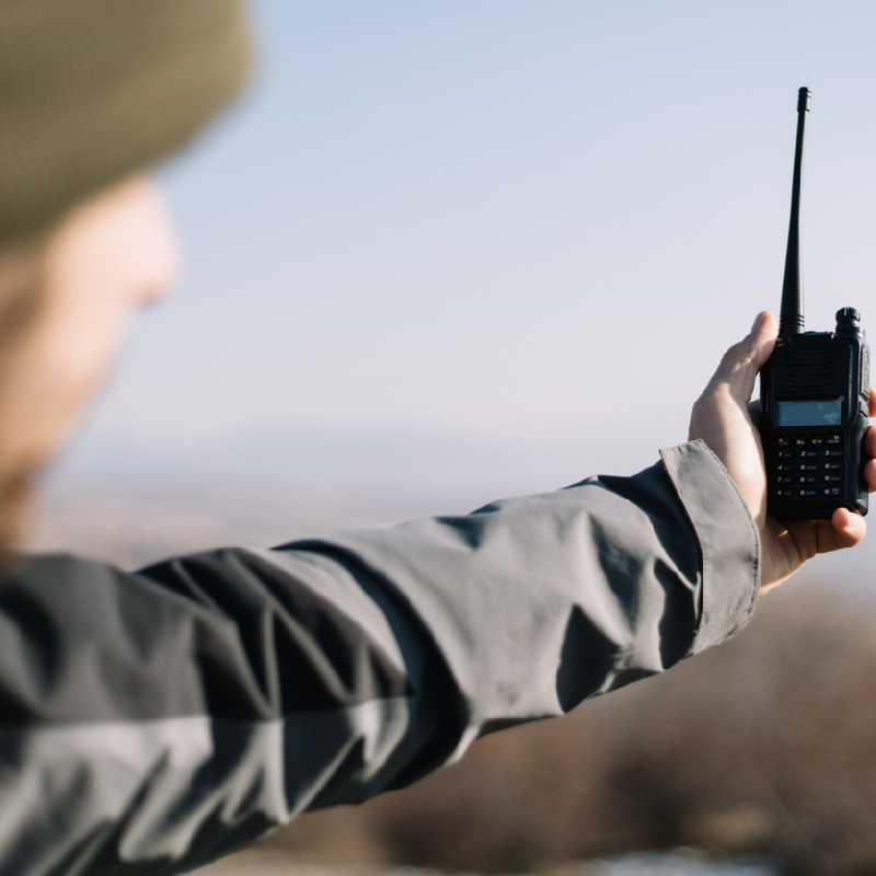 man holding a gmrs radio looking for reception