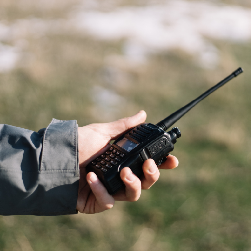 man holding a gmrs radio outdoors