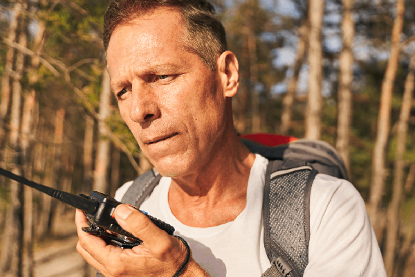 man holding a gmrs radio in the outdoors