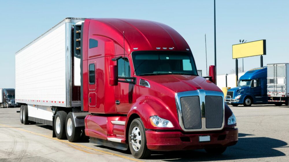 Picture of parked semi-truck with bright red cab