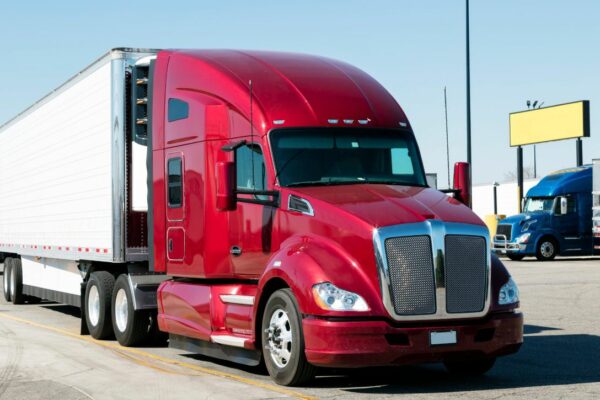 Picture of parked semi-truck with bright red cab